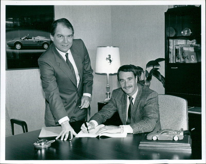 Nigel Mansell signs a contract to become Ferrari's UK dealer. - Vintage Photograph