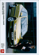 The new Citroën Xsara Coupé model is displayed in a promotional event. - Vintage Photograph