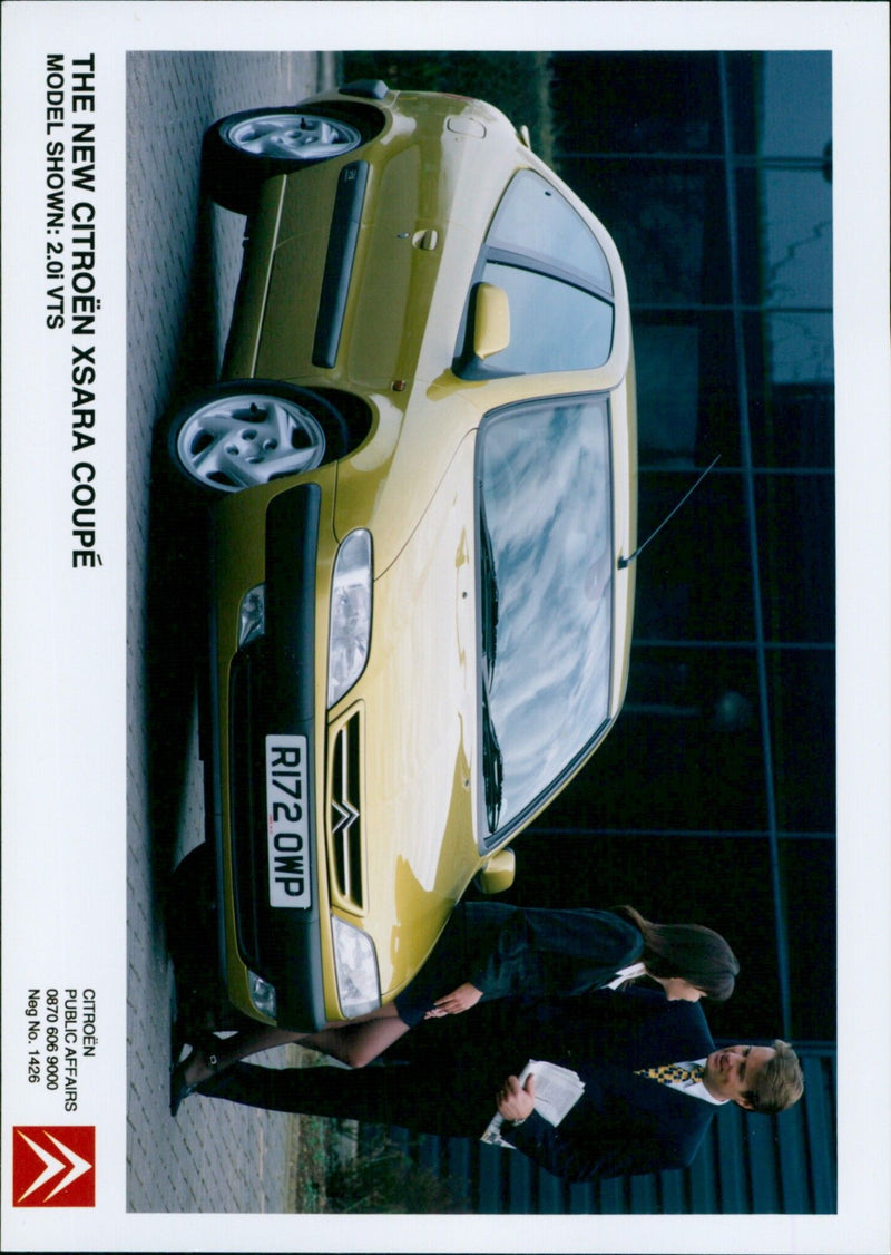 The new Citroën Xsara Coupé model is displayed in a promotional event. - Vintage Photograph