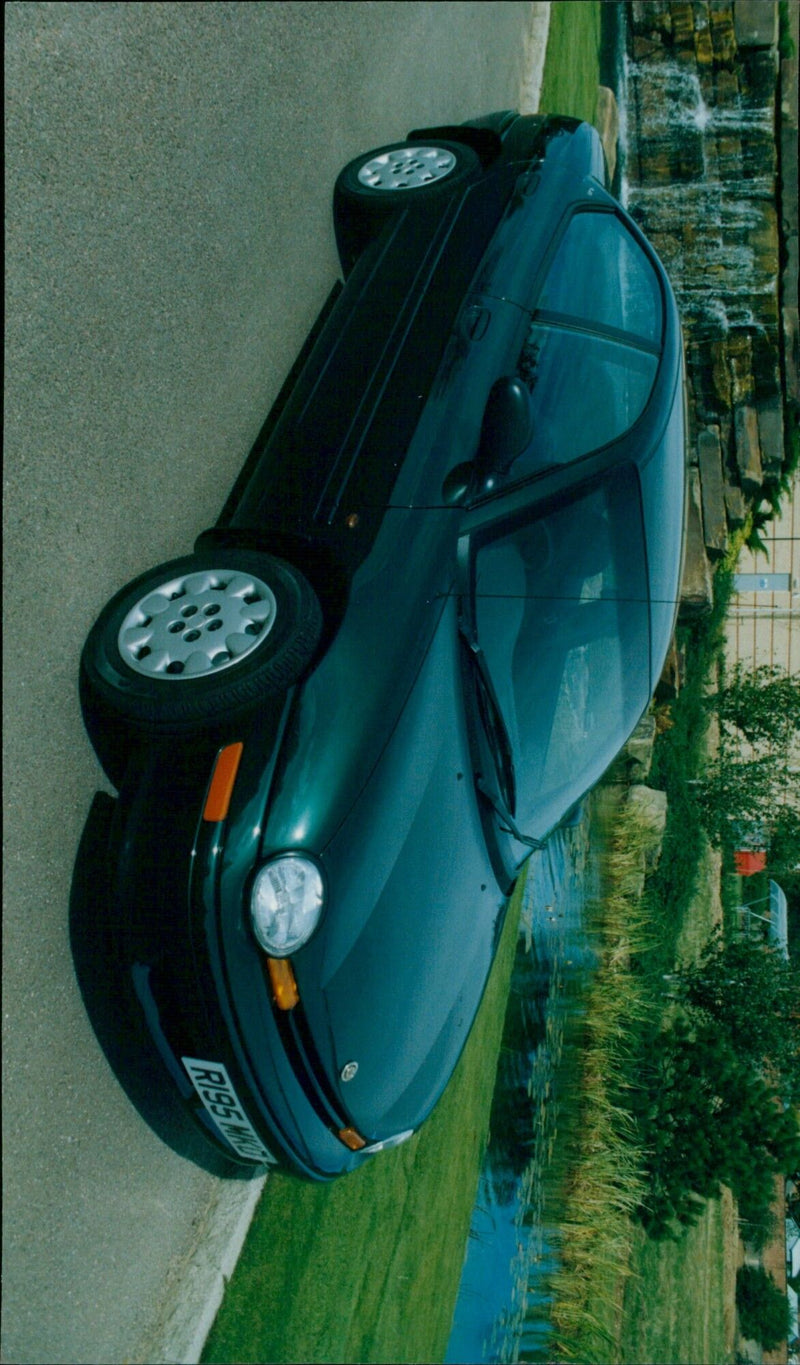 Automotive journalist testing a Chrysler Neon on the streets of Canada. - Vintage Photograph