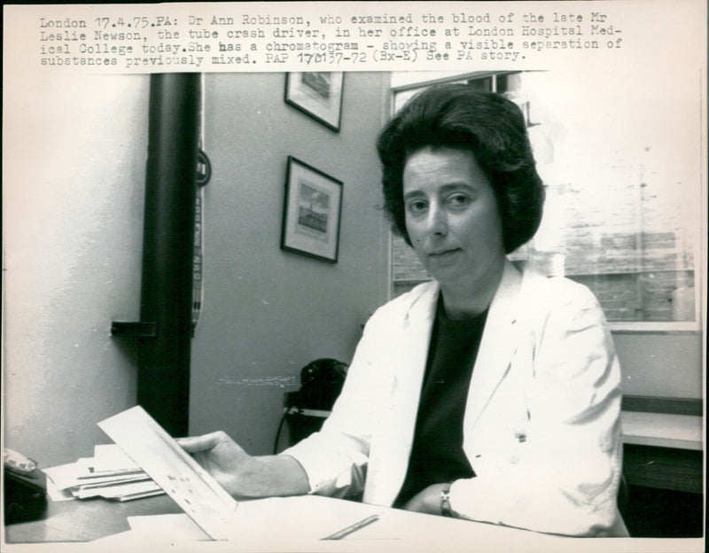 Dr Ann Robinson examines the blood of the late Mr Leslie Newson in her office at London Hospital Medical College. - Vintage Photograph