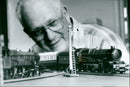 Doug Eeles stands with his model Great Western Engines at AALA Models trains. - Vintage Photograph