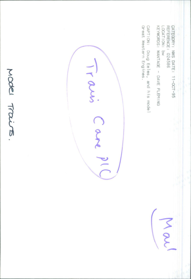 Doug Eeles poses with a model of a Great Western Engine and a model Traus Care. - Vintage Photograph