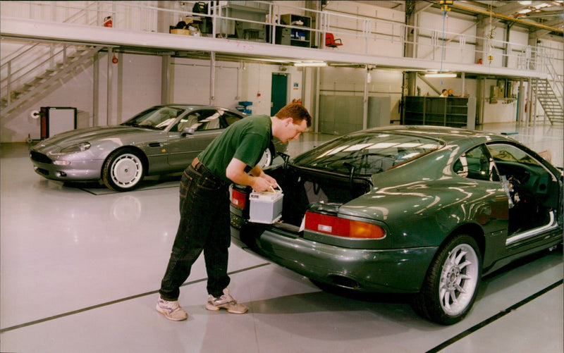 An Aston Martin DB7 with a Varta battery placed in the boot well. - Vintage Photograph