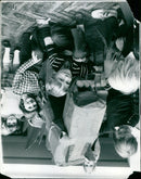 A large 3D dinosaur model is seen outside of a building. - Vintage Photograph