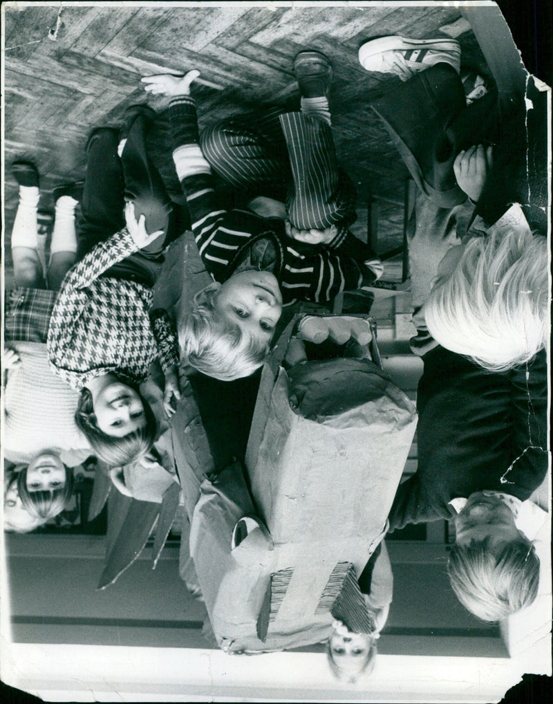 A large 3D dinosaur model is seen outside of a building. - Vintage Photograph