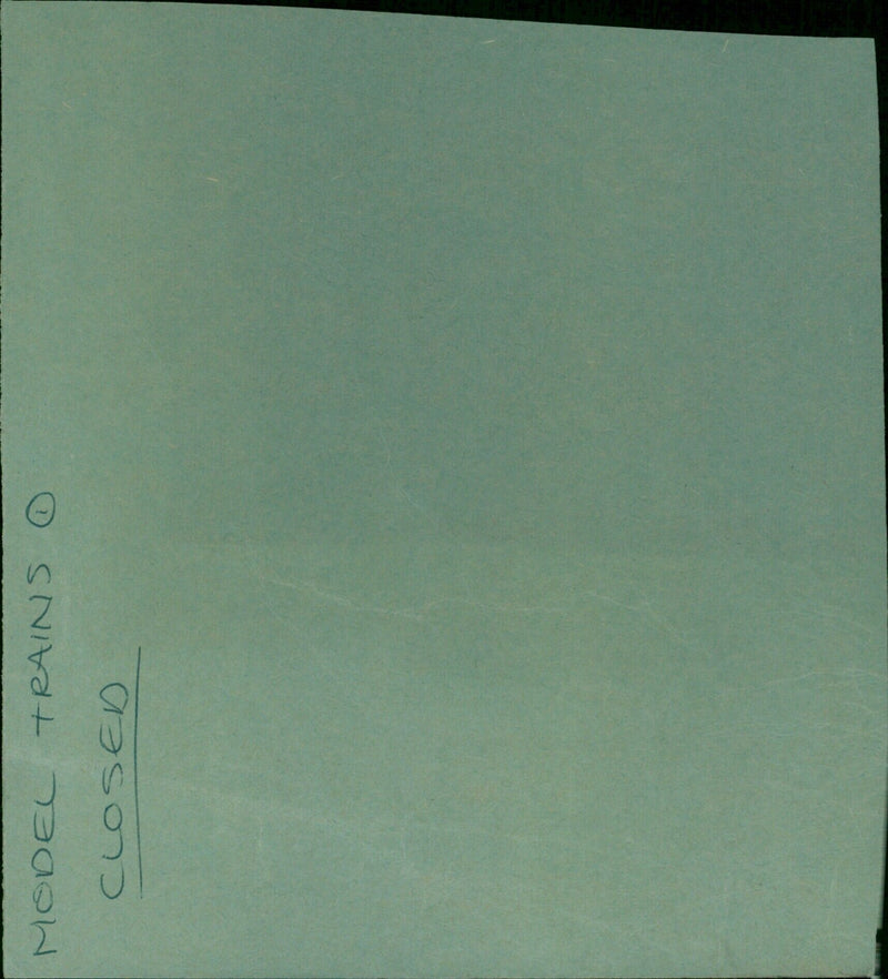 A model train set displayed in a closed AveryⓇ manilla folder. - Vintage Photograph