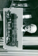 Stan Clarke stands amidst a blooming field of wildflowers. - Vintage Photograph