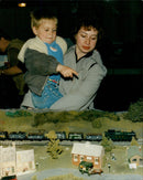 Mrs. Diane Prewer and her son Daniel, 3, admire a model railway at the Banbury Model Railway Exhibition. - Vintage Photograph