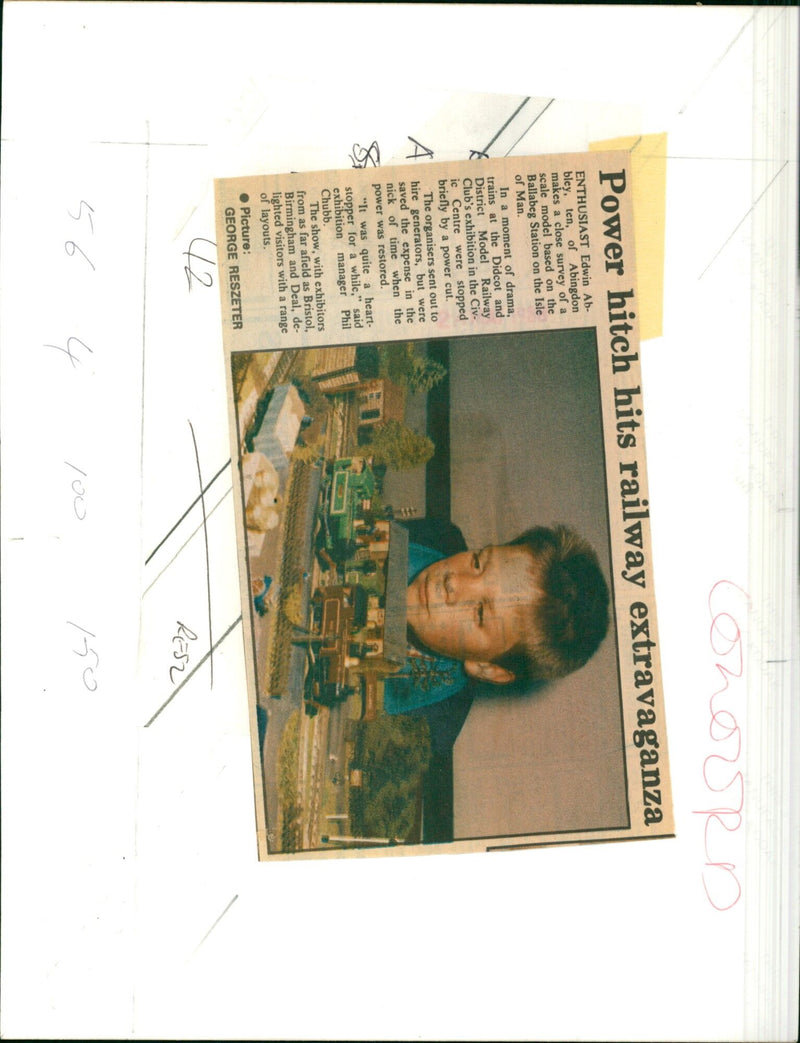 A ten-year-old enthusiast surveys a scale model of Ballabeg Station during a model railway exhibition. - Vintage Photograph