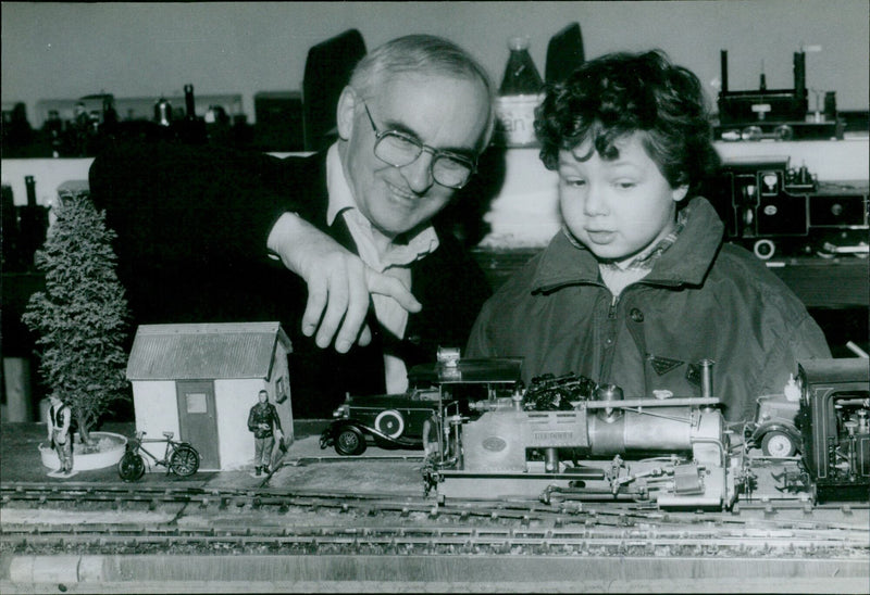 A young man examines a model of the Darjeeling Himalayan Railway Line at Exeter Hall in Kidlington, England. - Vintage Photograph