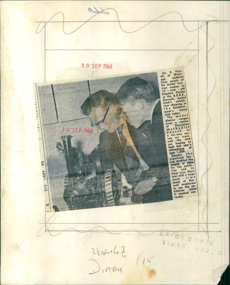 Mr. R. Powell explains the finer points of his model traction engine to Stephen Parker at the A.E.R.E. model exhibition showing at the Harwell social club. - Vintage Photograph