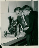Mr. R. Powell explains the finer points of his model traction engine to Stephen Parker at the A.E.R.E. model exhibition showing at the Harwell social club. - Vintage Photograph
