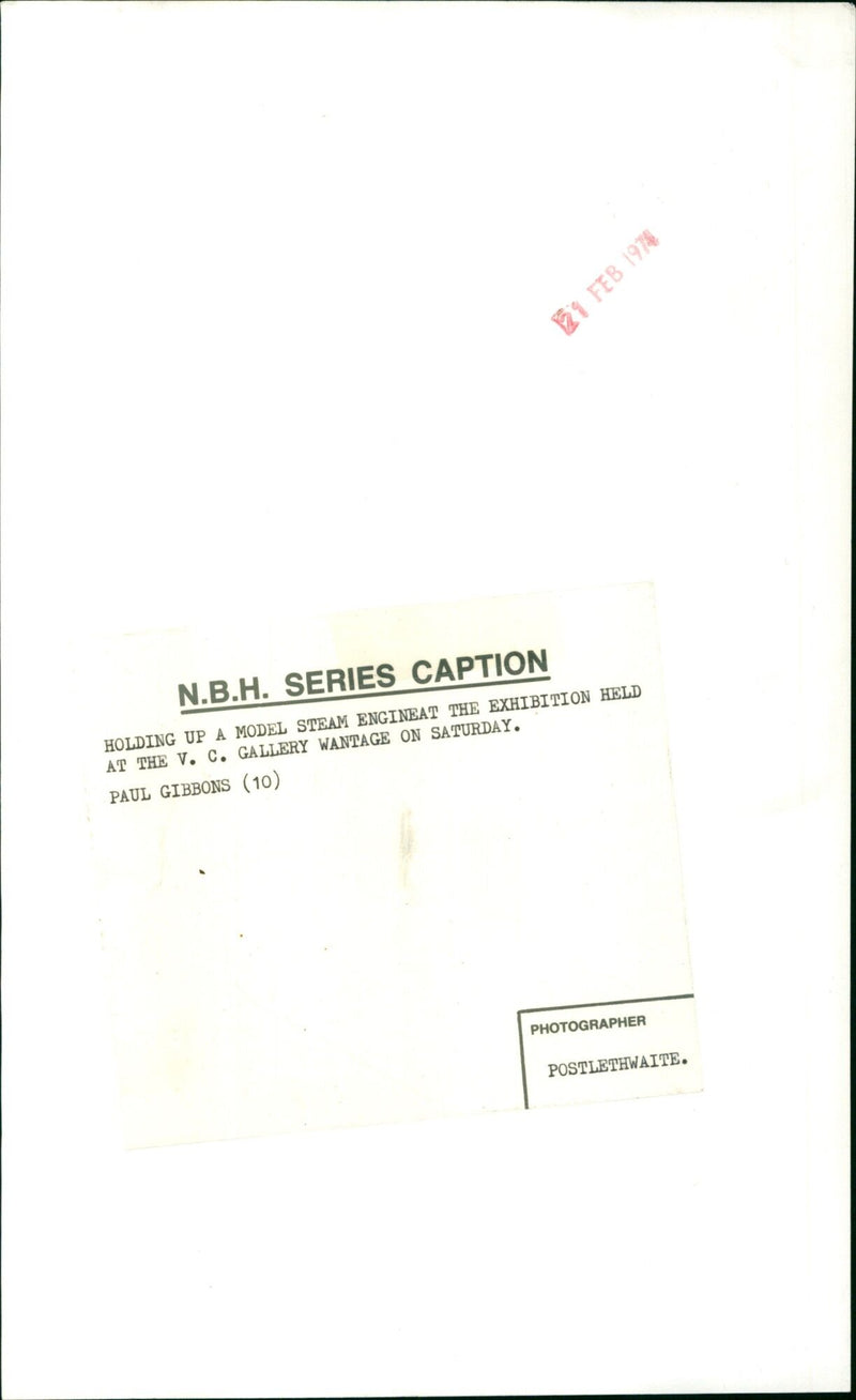 Paul Gibbons (10) holds up a model steam engine at a V.C. Gallery Wantage exhibition. - Vintage Photograph