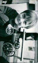 Paul Gibbons (10) holds up a model steam engine at a V.C. Gallery Wantage exhibition. - Vintage Photograph