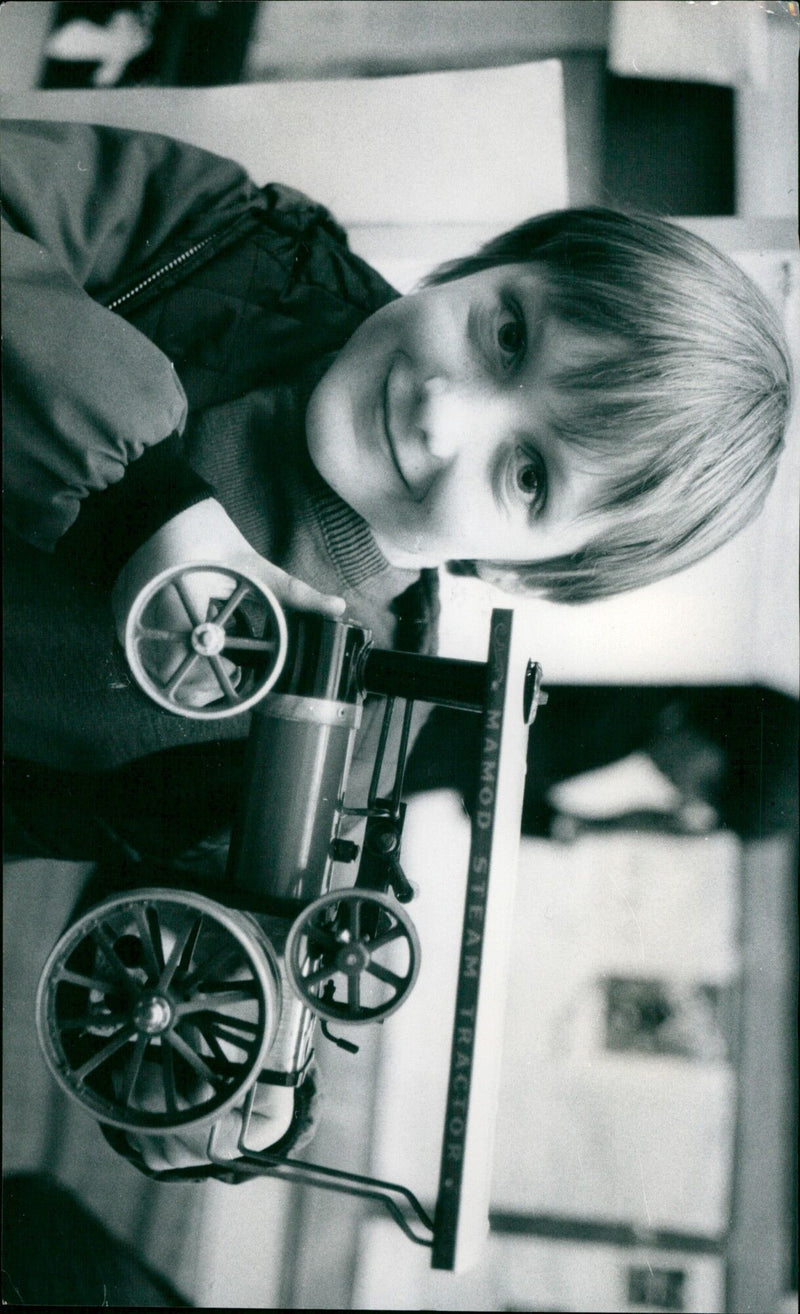 Paul Gibbons (10) holds up a model steam engine at a V.C. Gallery Wantage exhibition. - Vintage Photograph