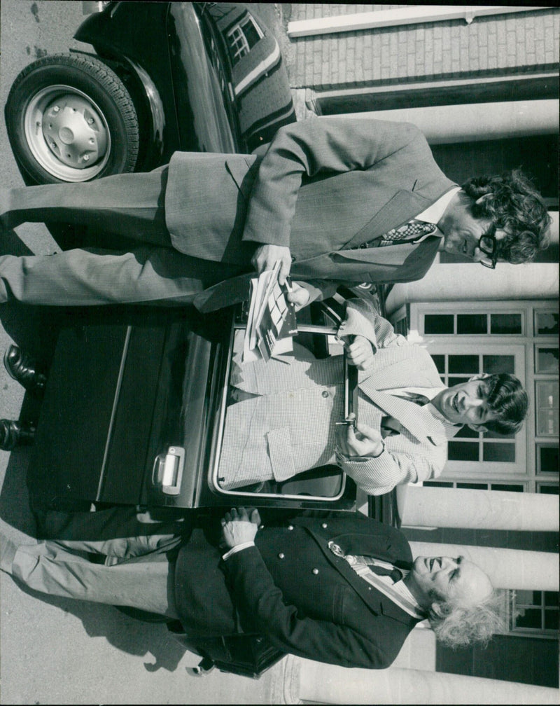 Mr. Chris Brown poses with the Fiat car he won from the Round Table and Rotary Club in Oxford, MA. - Vintage Photograph