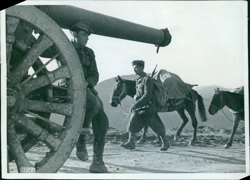 Italian artillery on the march towards advanced positions on the Greek-Albanian front during World War II. - Vintage Photograph