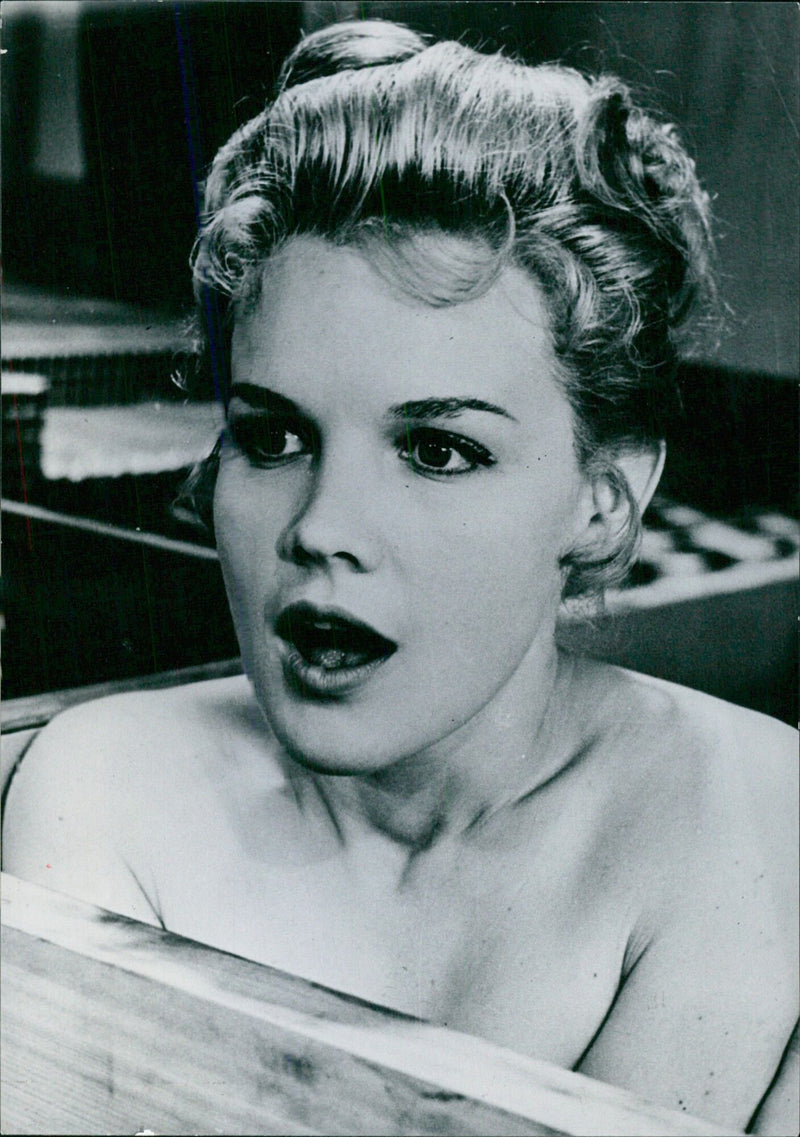 American actress Carroll Baker, famous for her role as "Baby Doll", appears in a scene from the film "Un ponte verso il sole", directed by Etienne Perier. - Vintage Photograph