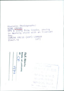 The iconic singer-songwriter Bing Crosby strikes a pose with his Alsatian dog in a 1974 photograph. - Vintage Photograph