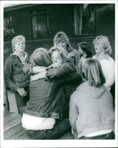 A fashion photographer poses with a model on a studio set. - Vintage Photograph