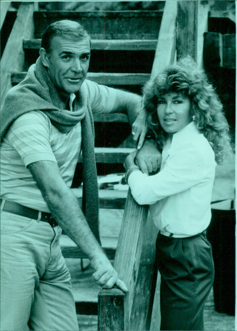 Actor Sean Connery and his wife, painter Micheline Roquebrune, embrace in 1984. - Vintage Photograph