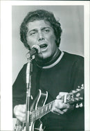 A group of people stand in the snow, illuminated by the light of the night sky, in a winter landscape in Sweden in 1976. - Vintage Photograph