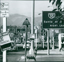 A mass of traffic signs, a confusing landscape, and two hours of parking - this is the scene at one of the many busy intersections in Santa Monica, USA. - Vintage Photograph
