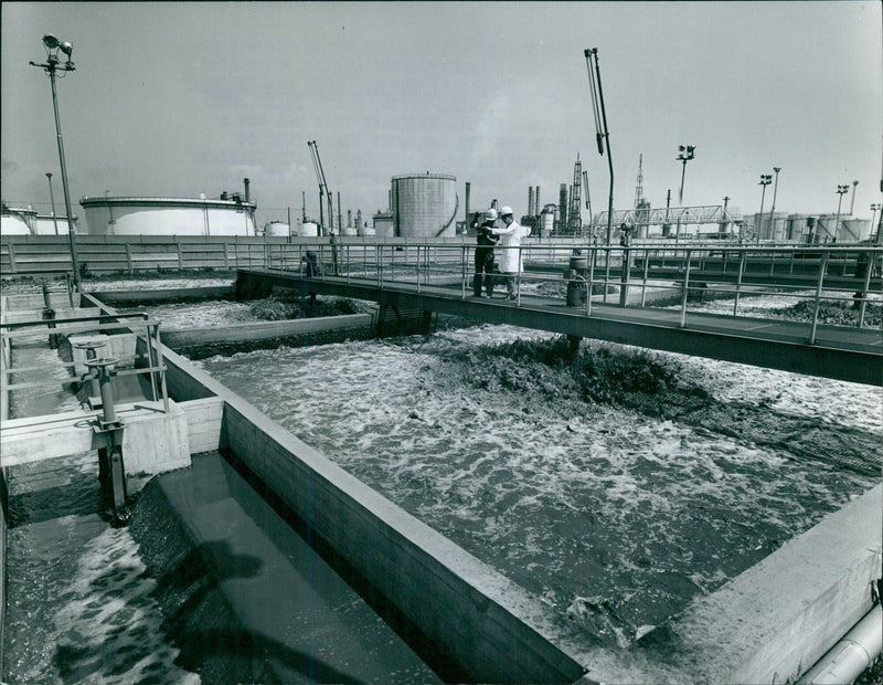 At the Italian oil refinery of Sannazzaro de Burgondi, near Pavia, engineers are installing a 100% sure water-depurator in an effort to defend water, air, and nature from pollution. - Vintage Photograph