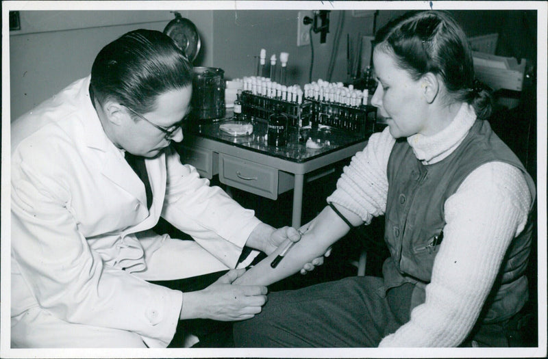 A Finnish Lotta has her blood tested in Helsinki in 1940 during Finland's struggle against the Soviet Union. - Vintage Photograph