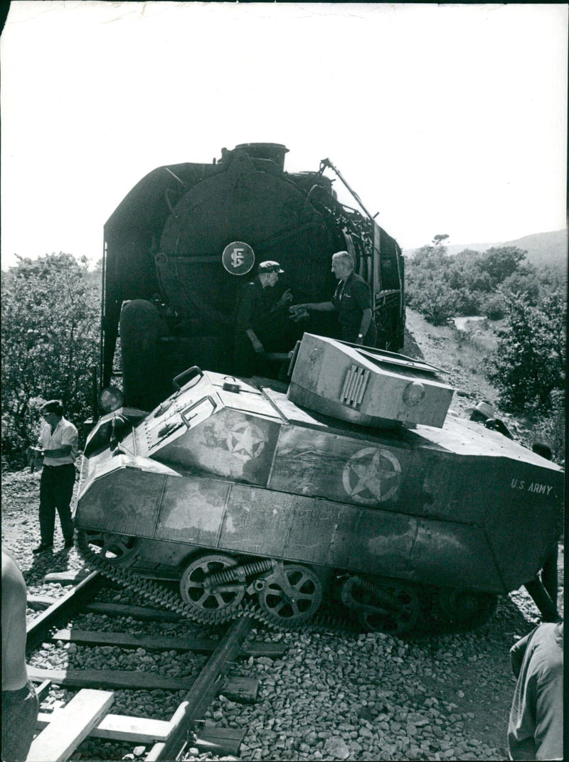 Hollywood actor Vittorio De Sica is slightly injured on the set of the MGM film "The Biggest Bundle of Them All" after a locomotive fails to stop in time and hits an armoured tank. Category: Entertainment - Vintage Photograph
