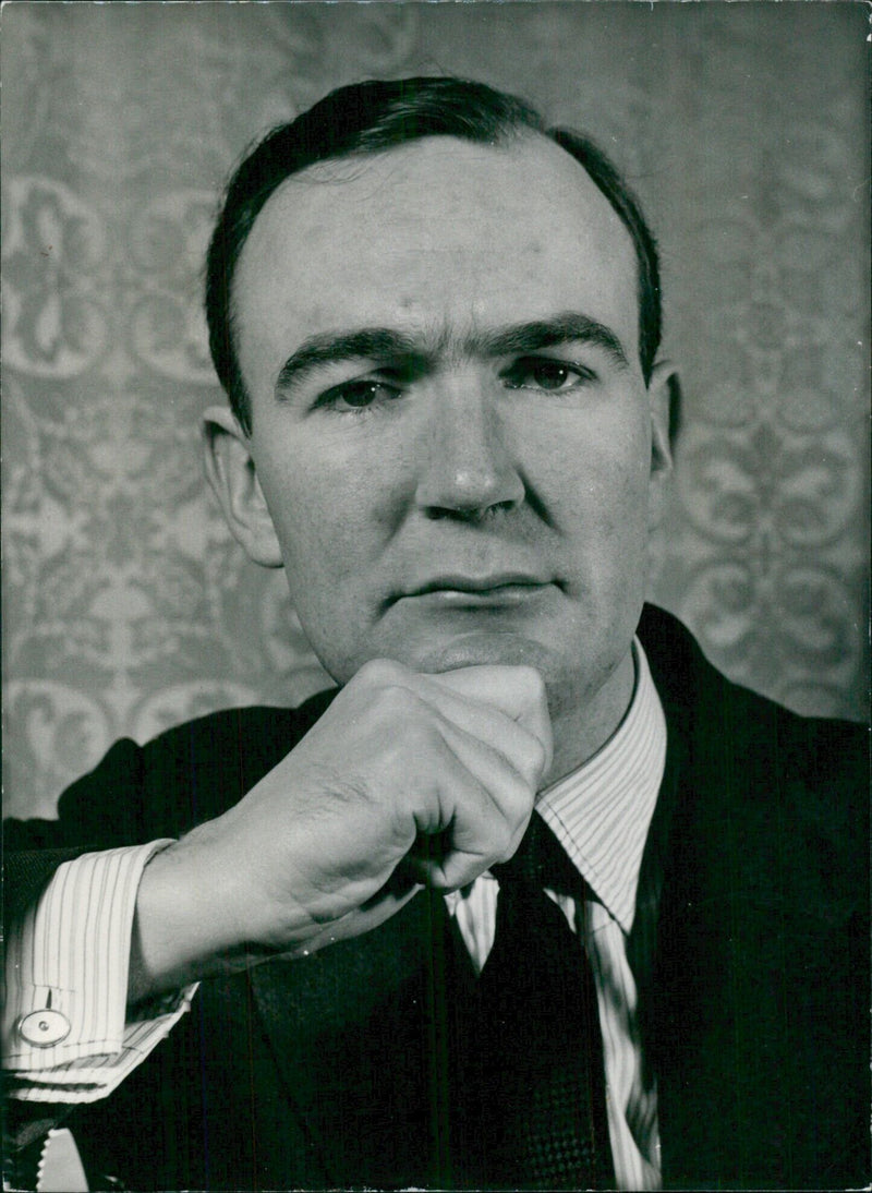 John Edward Poynder Grigg, 2nd Baron Altrincham of Tormarton, with his book "Two Anglican Essays" published in June, 1958. - Vintage Photograph