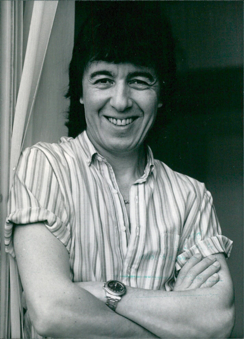 Rolling Stones bassist Bill Wyman poses for a portrait in 1985 following the release of his autobiographical video "Digital Dreams." - Vintage Photograph