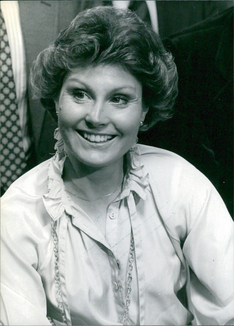 BBC television personality Angela Rippon smiles as she poses for a portrait in London in 1997. - Vintage Photograph