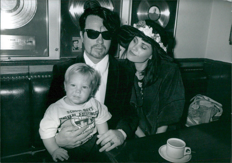 British rock stars Dave Stewart and his family, including his wife Siobhan Fahey and their son Sam, pose for a photo. - Vintage Photograph