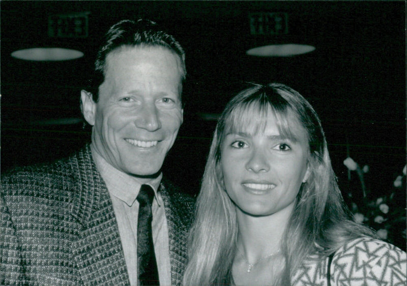 US actor Peter Strauss and his wife pose for a photograph in 1988. - Vintage Photograph