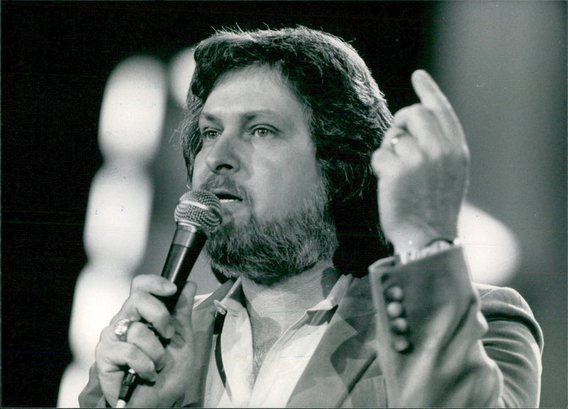 Joe Stampley, one of the most successful contemporary country music singers, performs in a concert. - Vintage Photograph