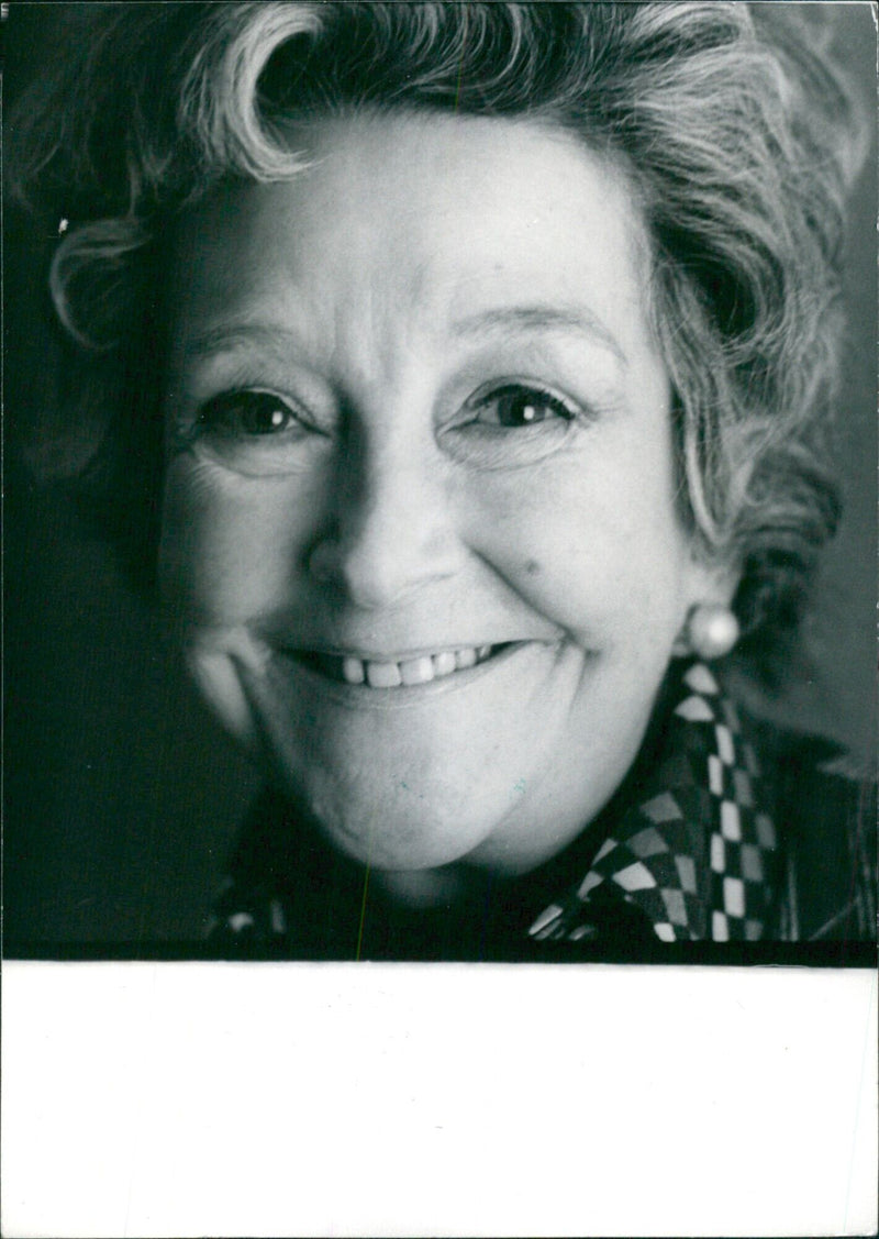 British actress Beryl Reid poses for a portrait in London, UK in 1987. - Vintage Photograph