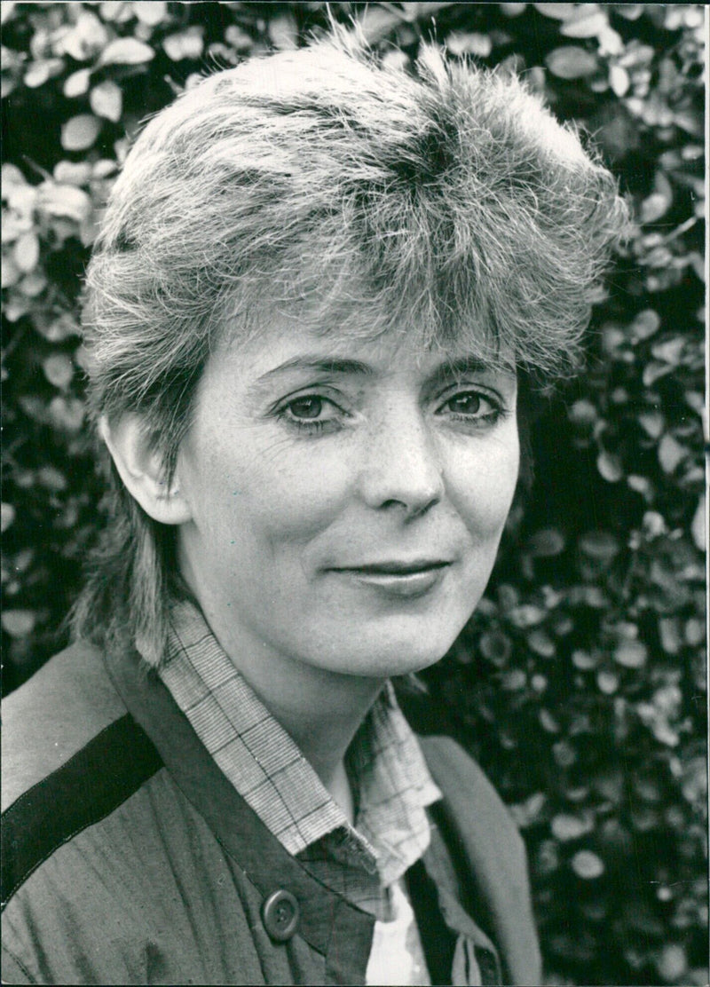 British actress Alison Steadman smiles for the camera at a 1983 press event in London. Steadman has had a successful career in stage and television, with credits including "Taking Leave," "Nuts in May," and "Esther Waters." - Vintage Photograph