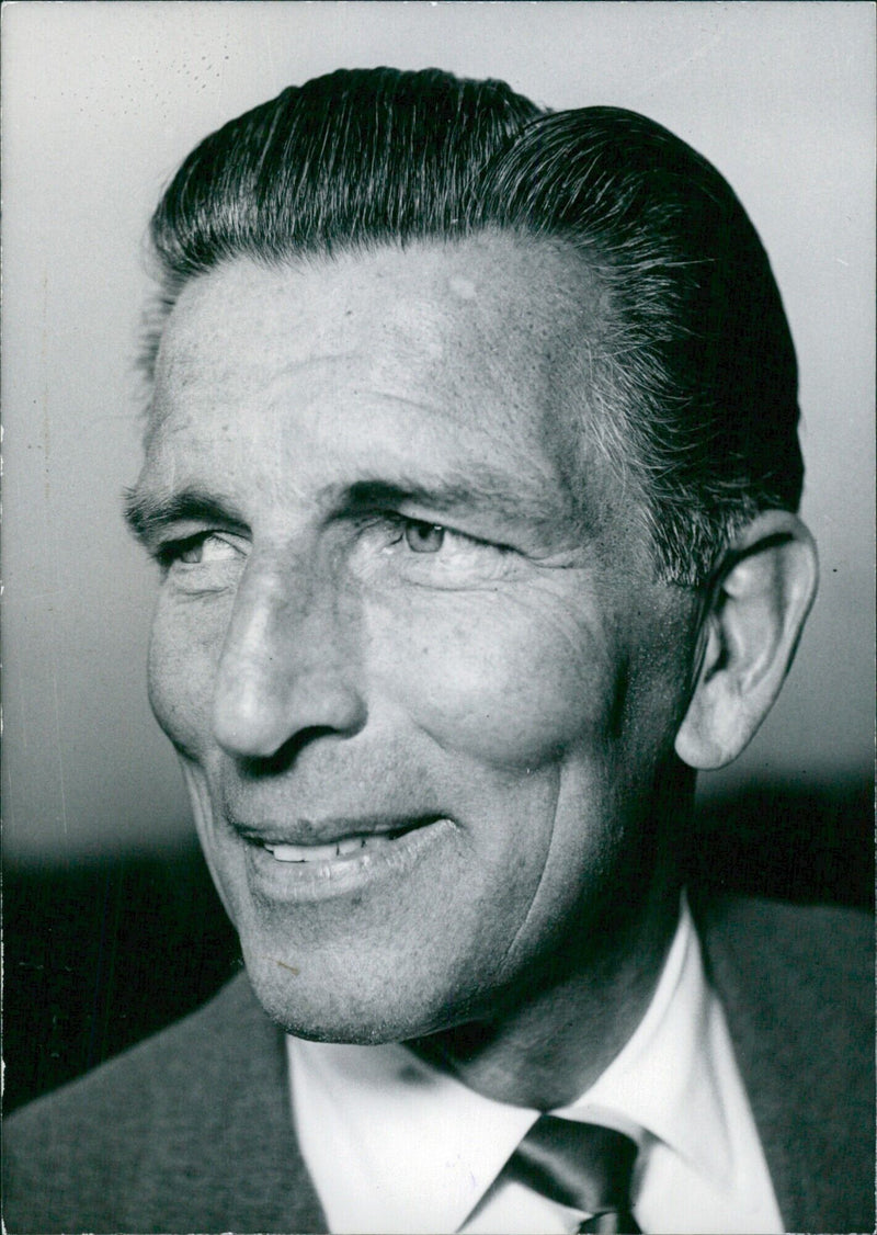 British actor Michael Rennie stands in front of the newly opened Panenbidiplats in Copenhagen, Denmark. - Vintage Photograph