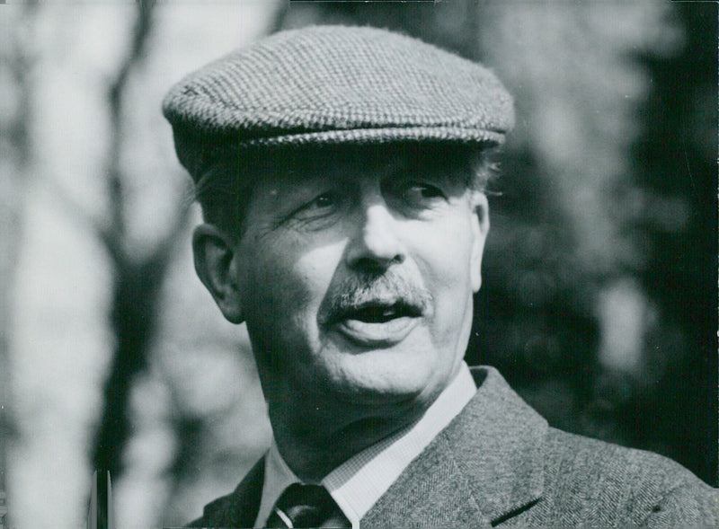 British Prime Minister Harold Macmillan wearing a tweed cap in 1950. - Vintage Photograph