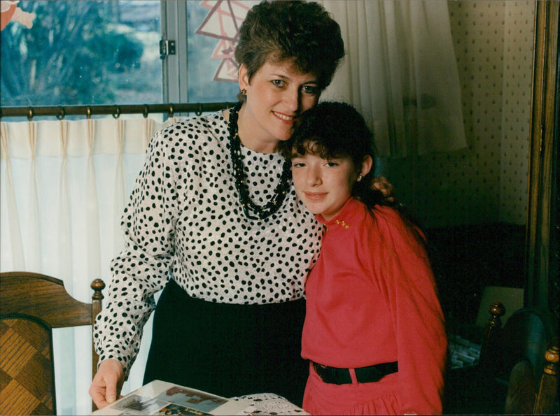 Betty Mahmoody and her daughter pose together in Sweden in an iconic photo from the film "Not Without My Daughter". - Vintage Photograph