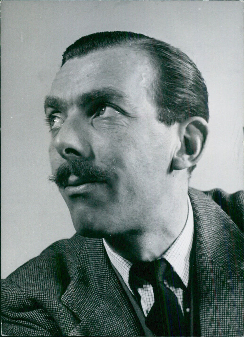 Frank Muir, renowned British scriptwriter and broadcaster, is captured in a study by photographer Tom Blau. - Vintage Photograph