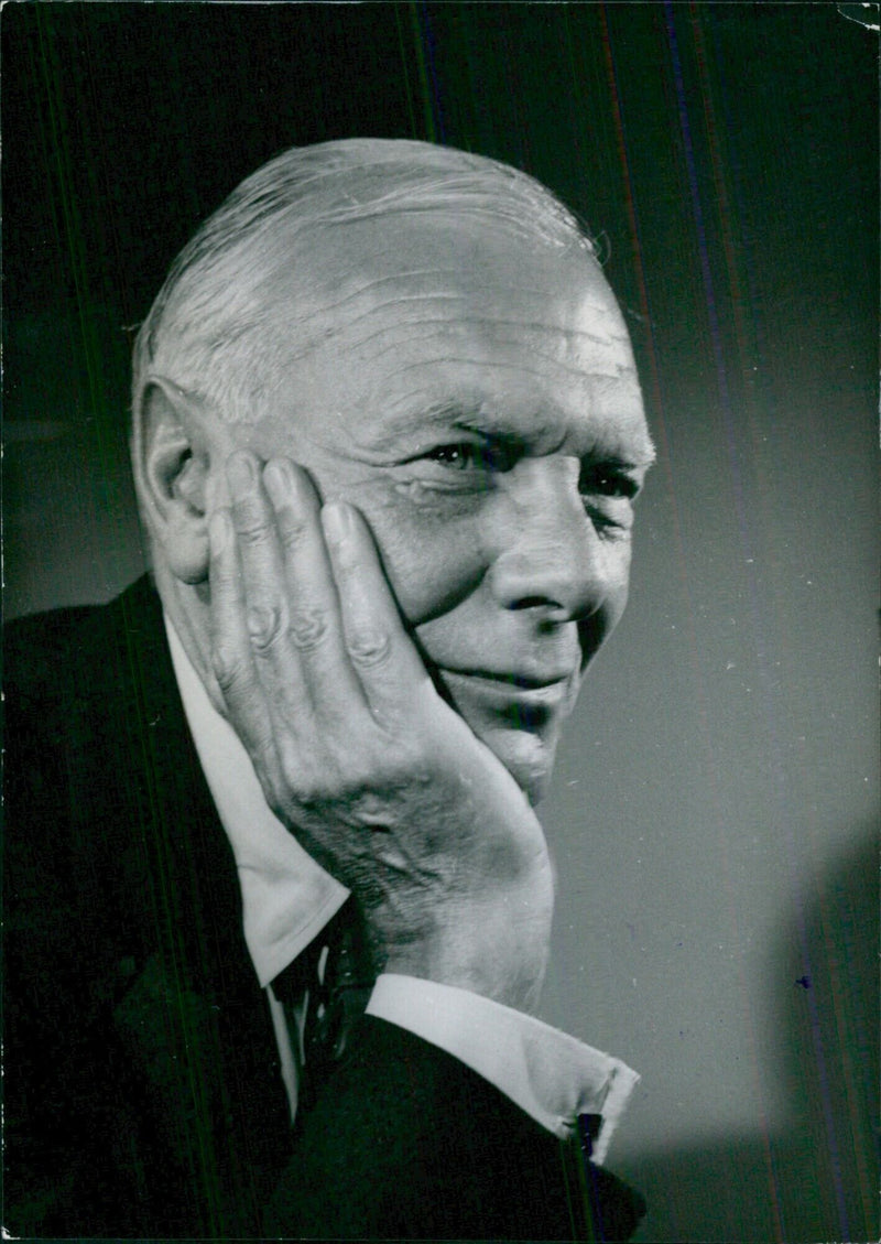 Author and broadcaster Malcolm Muggeridge is interviewed in a relaxed pose. - Vintage Photograph