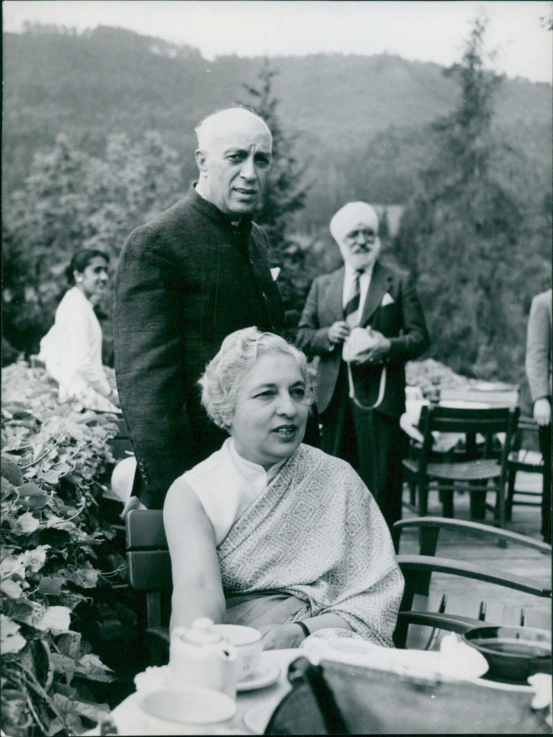 Indian Prime Minister Jawaharlal Nehru and his sister Mrs. R.S. Pandit pose for a photograph in Austria during a conference on India's foreign policy. - Vintage Photograph