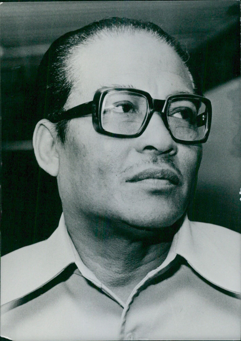 Indonesian politicians Lt.-Gen. SJARIF THAJEB, the Minister of Education and Culture since 1974, and CAMERA PRESS (IN/GEN) pose for a photograph in London, 1975. - Vintage Photograph