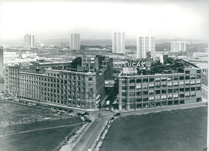 Employees enter the headquarters of Lucas Industries Ltd. in Great King Street, Birmingham, UK on (date). Lucas employ some 100,000 people, and have manufacturing or distribution facilities in 60 countries. - Vintage Photograph