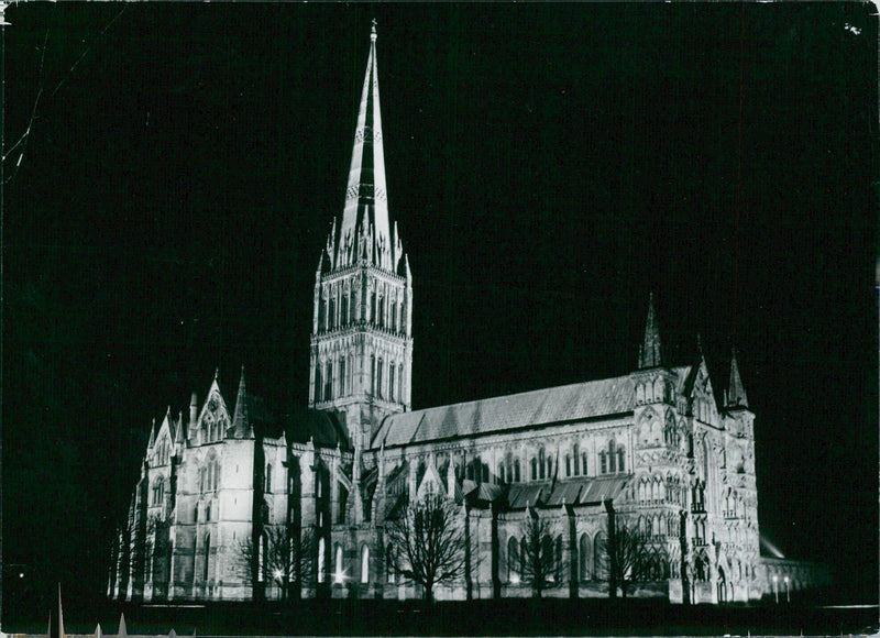 Salisbury Cathedral is illuminated by the night sky, showcasing its iconic 404-foot spire, the tallest in England.  Photographer: Michael Blackman, Camera Press London. - Vintage Photograph