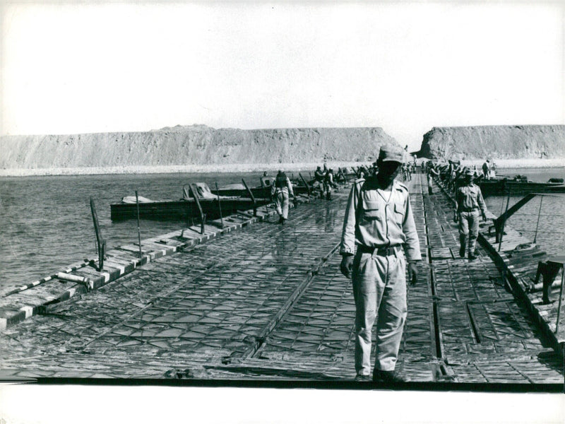 Egyptian soldiers construct a pontoon bridge across the Suez Canal during the 1973 Arab-Israeli War. - Vintage Photograph