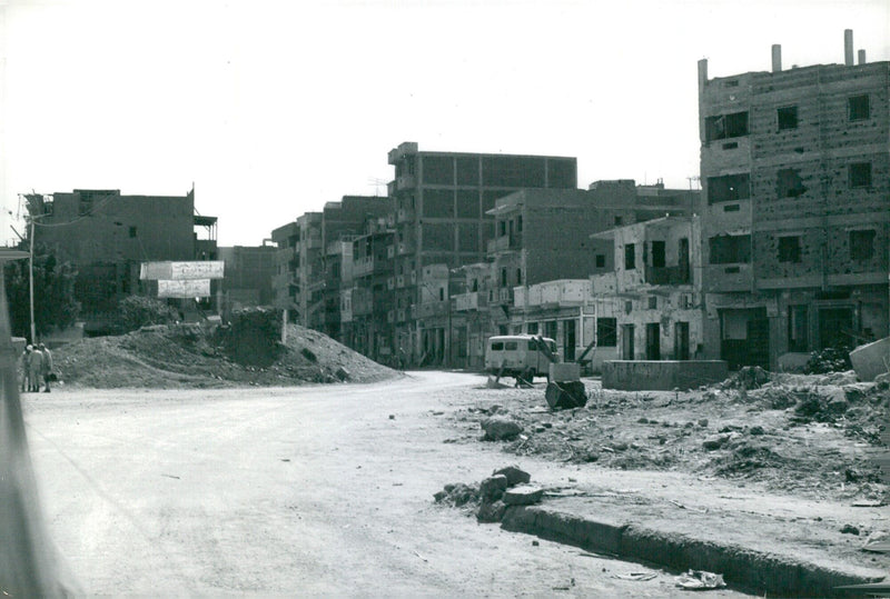 Destruction of Suez Town visible in this aerial view of the West Bank of the Suez Canal following the 1973 Arab-Israeli War. - Vintage Photograph